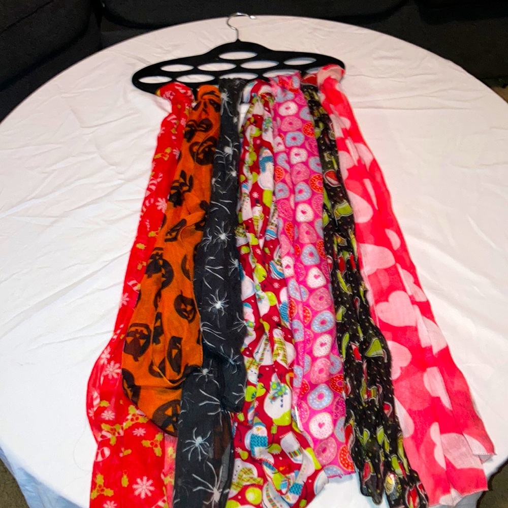 seven different scarves with scarf hanger